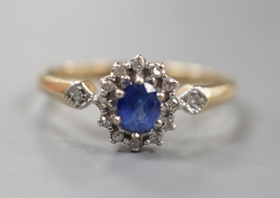 A modern 9ct gold, sapphire and diamond set cluster ring, size R, gross 2.3 grams.